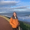 Anna Williams, species recovery engagement officer, standing outside with the sea behind her