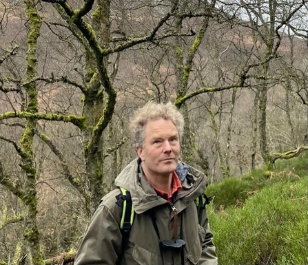 Walter Riddell standing in a woodland